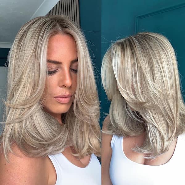 Shoulder-Length Blonde Haircut with Feathered Ends